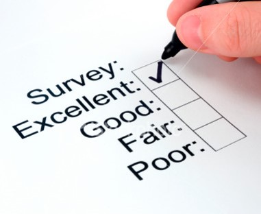 Close-up of survey response form with person checking the "excellent" choice.